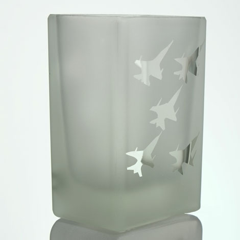 Five fighter jets flying in a diamond formation