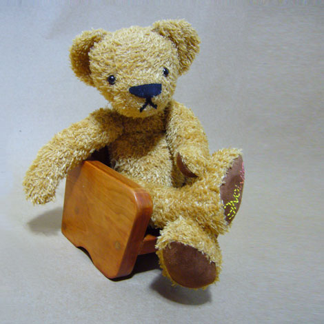 teddy crossed legged and looking sad