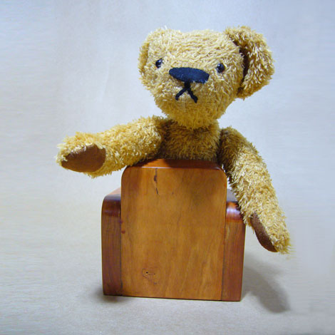 Simone leaning over back of chair looking anxious