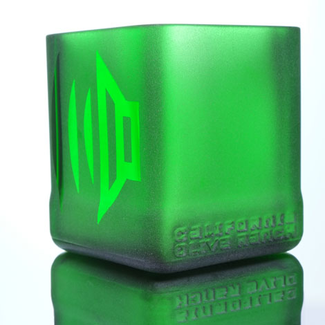 speakers, one on either side of green glass