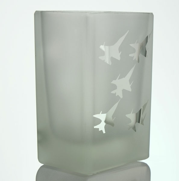 Five fighter jets flying in a diamond formation