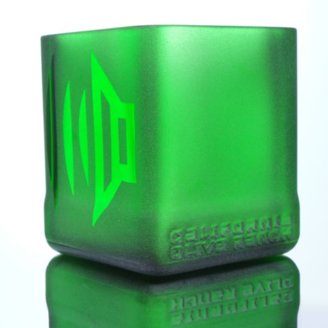 Speakers, one on either side of green glass